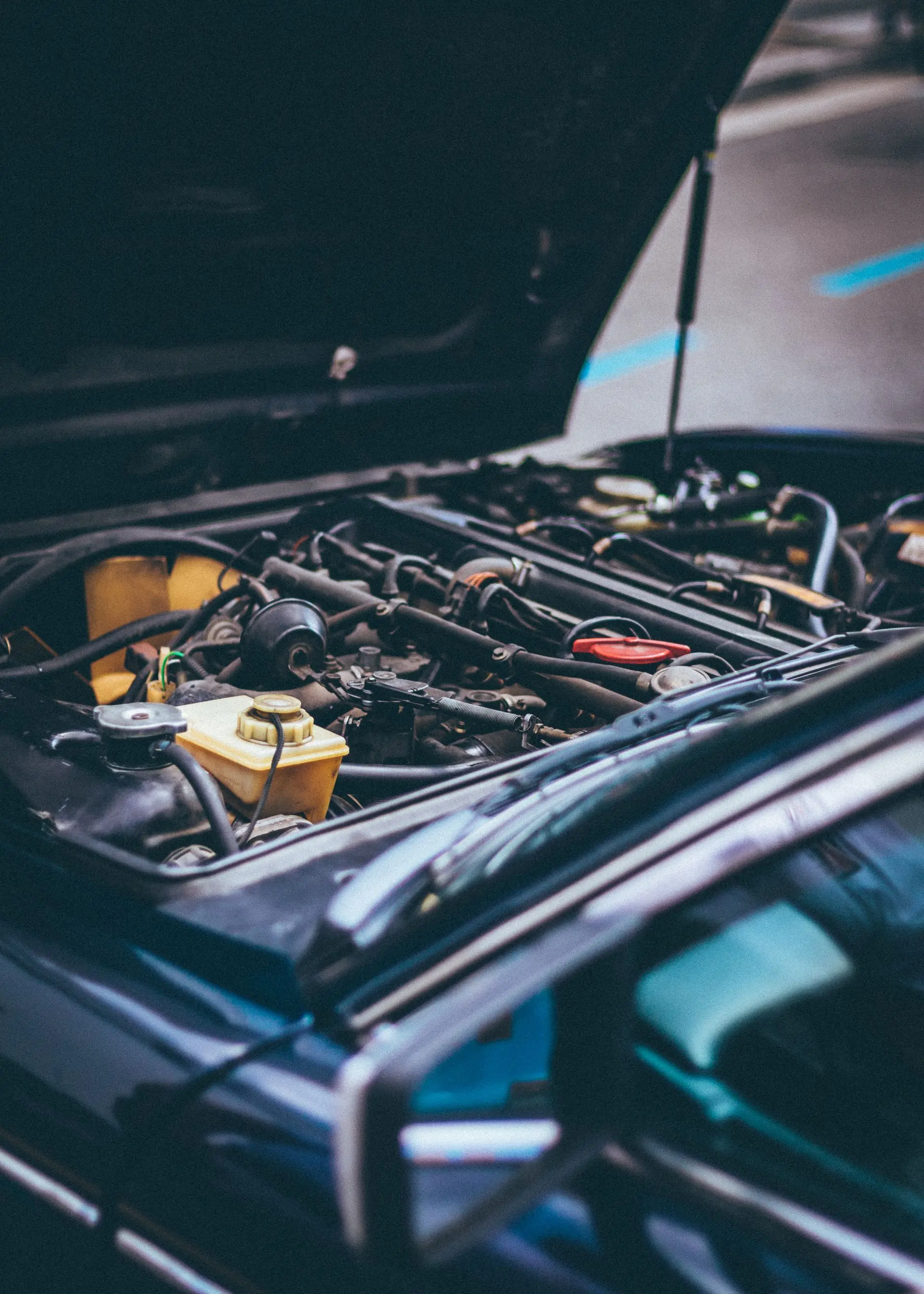 Motor de un auto con el capó abierto en el taller